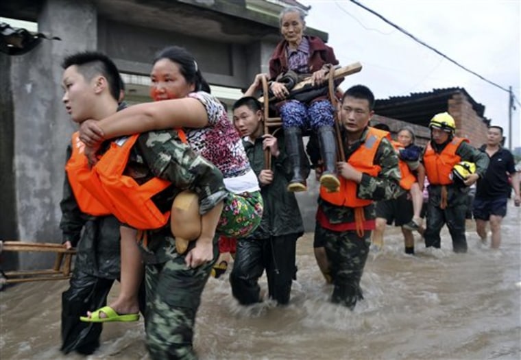 Rescue workers evacuate residents from flooded areas in Jianong town in Leshan in southwest China's Sichuan province on Sunday, July 18, 2010. Flooding  and landslides in communities along the Yangtze River and other scattered parts of China have killed more than 130 people so far this month. (AP Photo)**CHINA OUT**